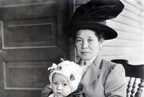 Woman holding child sitting in rocking chair (ddr-densho-474-216)