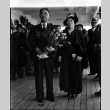 Man holding flowers and woman on board ship (ddr-densho-426-2009)