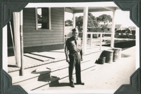 Man in uniform standing outside building (ddr-ajah-2-114)