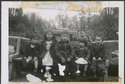 Five children sitting on park bench (ddr-densho-483-1010)