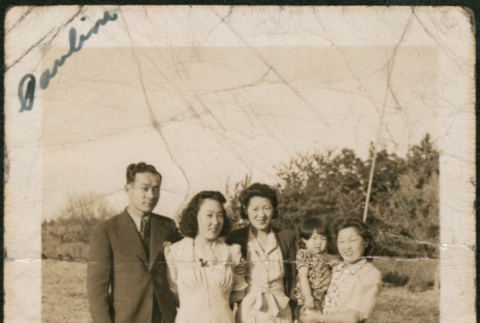 Three women, a man and child standing in field (ddr-densho-316-377)