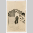 Man in front of barracks (ddr-densho-545-4)