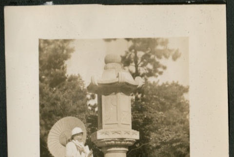 Women with parasol poses by monument (ddr-densho-359-856)