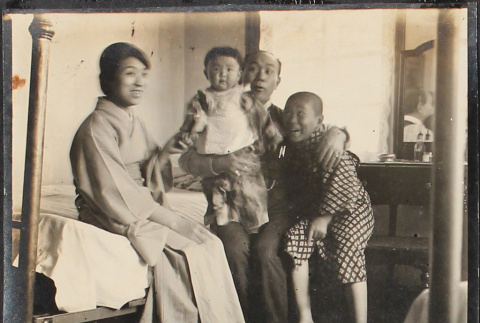 A family sitting on a bed (ddr-densho-278-83)