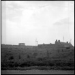 View of buildings and walls of fort from shore (ddr-densho-329-706)