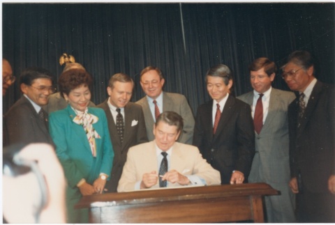President Ronald Reagan signing the Civil Liberties Act of 1988 (ddr-densho-10-173)