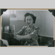 Woman poses at desk (ddr-densho-397-59)