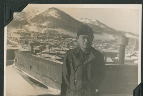 Nisei soldier poses in front of Mount Hakodate (ddr-densho-397-301)