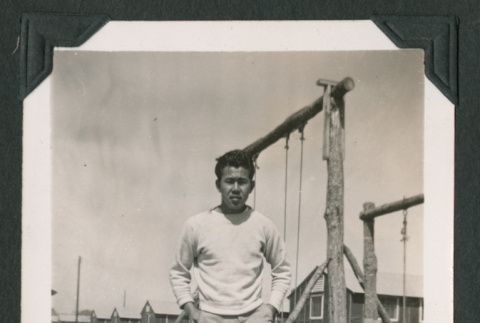 Man stands by swings (ddr-densho-471-53)