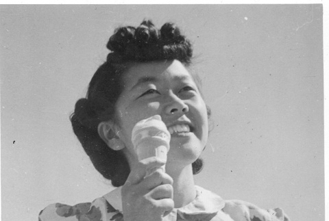 Nisei woman eating ice cream (ddr-densho-157-32)