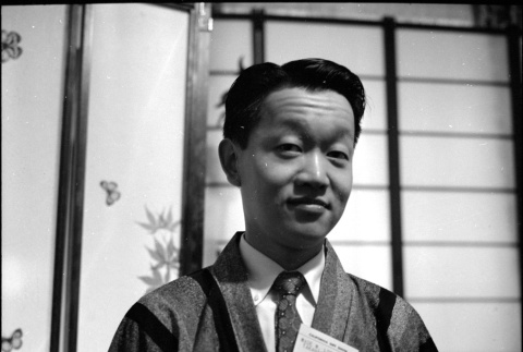 Man in robe, with name tag (ddr-densho-426-2475)