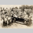Franklin D. Roosevelt and Eleanor Roosevelt in a car surrounded by teenagers (ddr-njpa-1-1518)