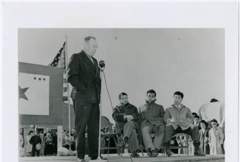 Heart Mountain Camp director Guy Robertson announcing draftees leaving for the army, 1944 (ddr-densho-122-719)