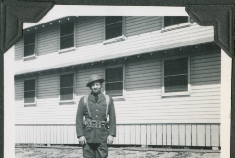 Man in uniform standing outside building (ddr-ajah-2-77)