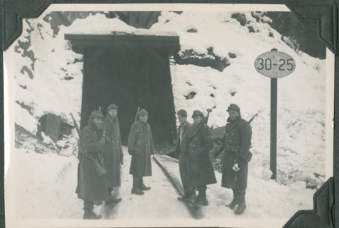 Six men standing outside train tunnel in snow (ddr-ajah-2-314)