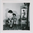 A woman and young girl seated next to a Japanese doll (ddr-densho-338-16)
