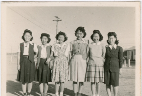 Six women standing outside of barracks (ddr-densho-458-63)