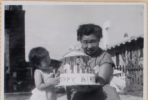 Yoshiko Shiomi holding a cake with Susan Shiomi (ddr-densho-522-241)