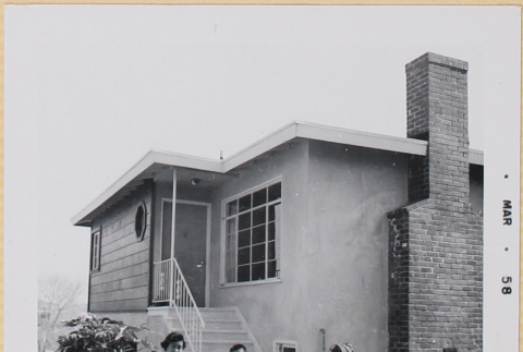Yoshiko, William, Susan and Leslie Shiomi sitting on steps of house (ddr-densho-522-494)