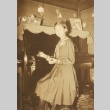 Girl posing at a piano (ddr-njpa-4-1330)