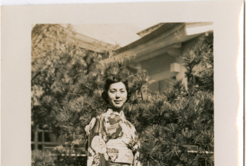 Woman in kimono standing in garden (ddr-densho-426-1866)