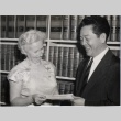 Chuck Mau accepting a check from a Pythian Sisters representative (ddr-njpa-2-688)