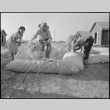 Japanese Americans filling straw mattresses (ddr-densho-37-404)