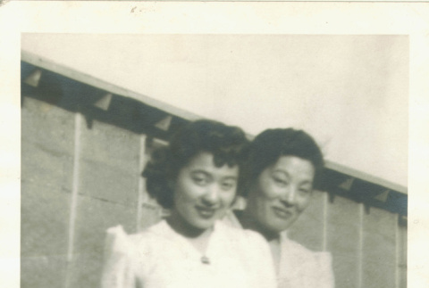 Mother and daughter behind barracks (ddr-densho-118-6)