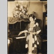 Girl in kimono reading sheet music (ddr-njpa-4-195)