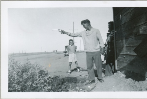 A man pointing a gun (ddr-densho-300-108)