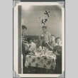 Group siting around a dining table. (ddr-densho-321-444)