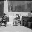 Japanese Americans waiting with baggage (ddr-densho-151-101)