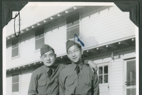 Two men standing outside barracks (ddr-ajah-2-389)