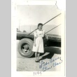 Signed photograph of a woman standing in front of a flatbed truck (ddr-manz-6-71)