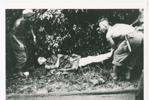 Serviceperson in Burma with splint on broken leg (ddr-densho-1007-19)
