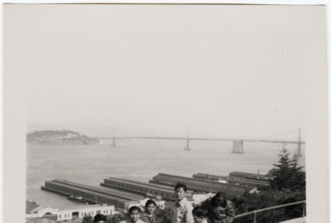 Group standing at overlook with Oakland Bay Bridge in background (ddr-densho-426-954)