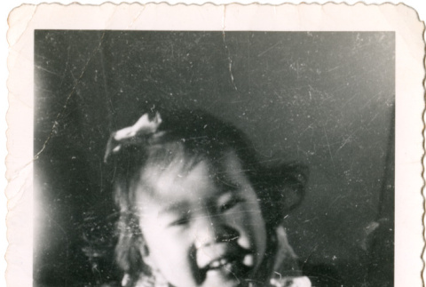 Girl smiling at camera (ddr-densho-430-178)