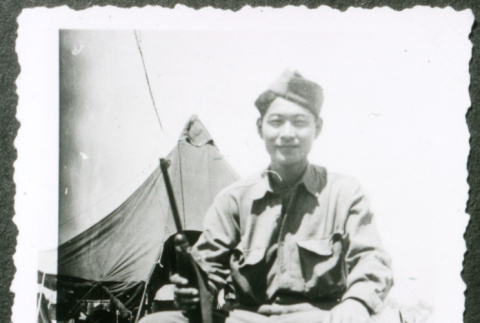 Soldier in chair in front of tent (ddr-densho-1007-858)