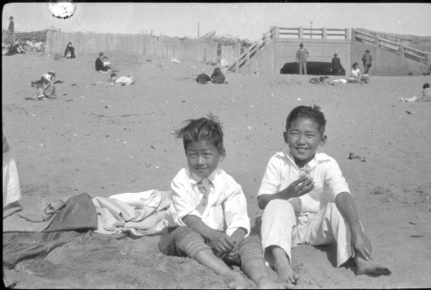 Two boys sitting on beach (ddr-densho-426-2002)