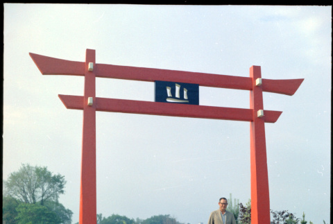Man standing by Torii Gate at D. Hill Nursery (ddr-densho-377-1444)