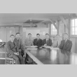 Men seated around a table in an office barracks (ddr-fom-1-380)