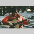 Ted Hasegawa playing guitar at morning watch (ddr-densho-336-1239)