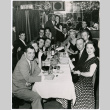Mary Mon Toy and Jose Villa Nueva with large group seated at a table (ddr-densho-367-155)