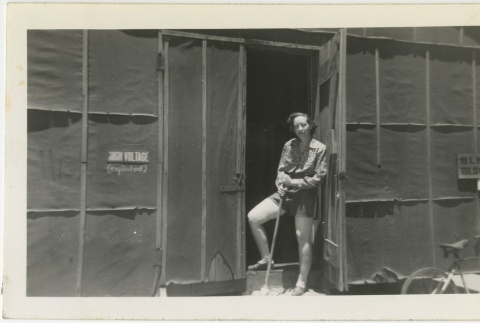 Woman standing in a barracks doorway (ddr-manz-7-46)