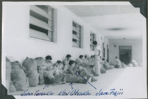 Soldiers sitting outside of a building (ddr-densho-201-791)