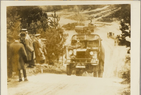 Men watching a military truck drive by (ddr-njpa-13-320)