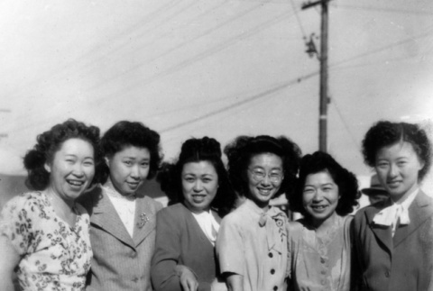 Group of five women posing for photo on sidewalk (ddr-ajah-6-429)