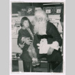 Susan Isoshima with Santa Claus (ddr-densho-477-269)