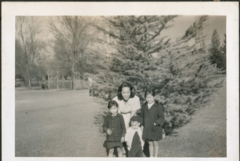 A woman and three children in a park (ddr-densho-298-193)