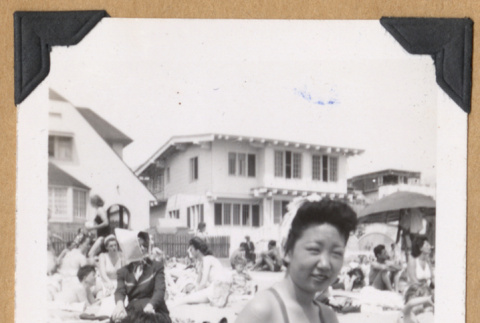 Two people on a crowded beach (ddr-densho-542-308)
